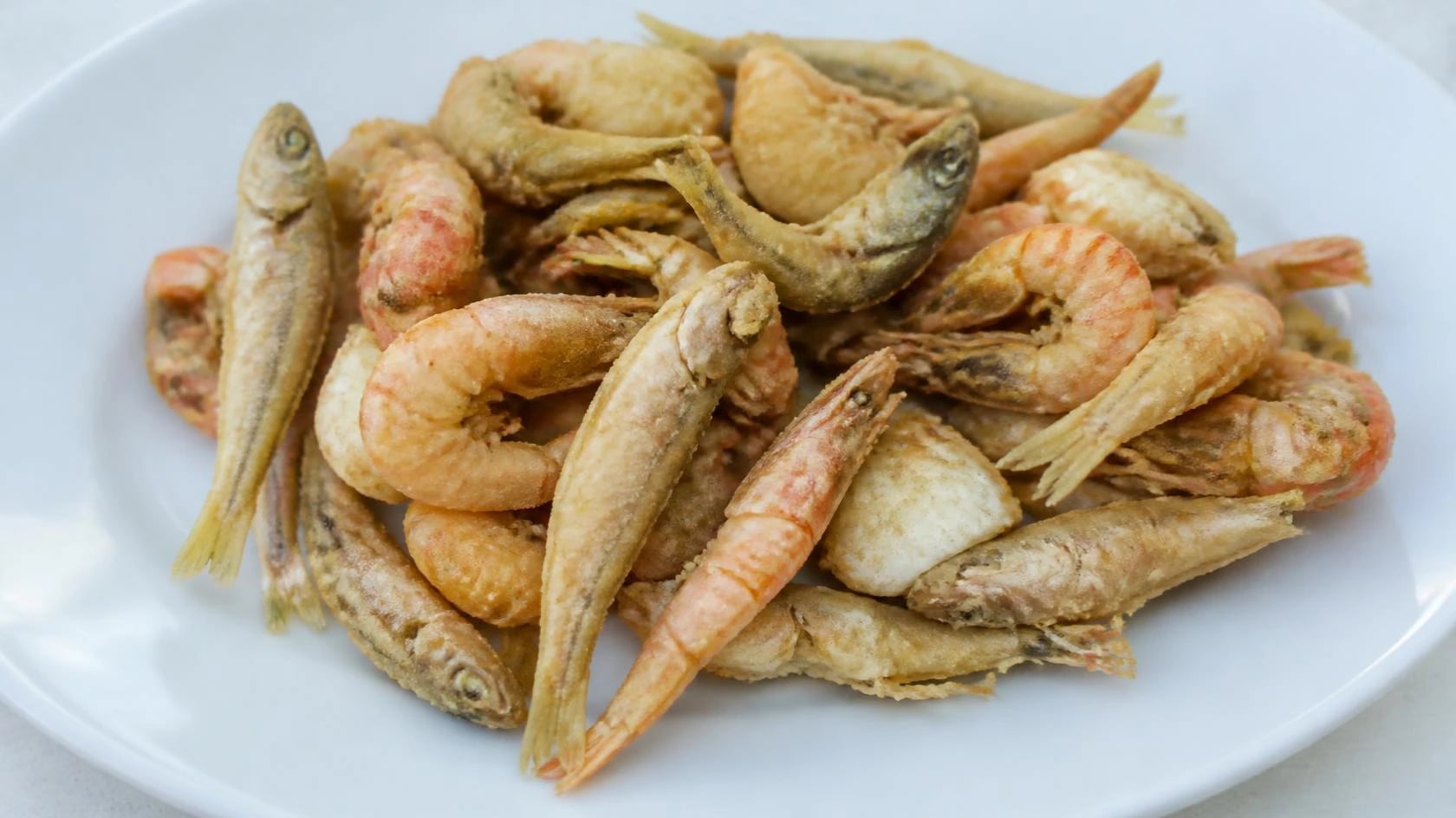 AI-made picture of Fritto misto (mixed deep fried fish)