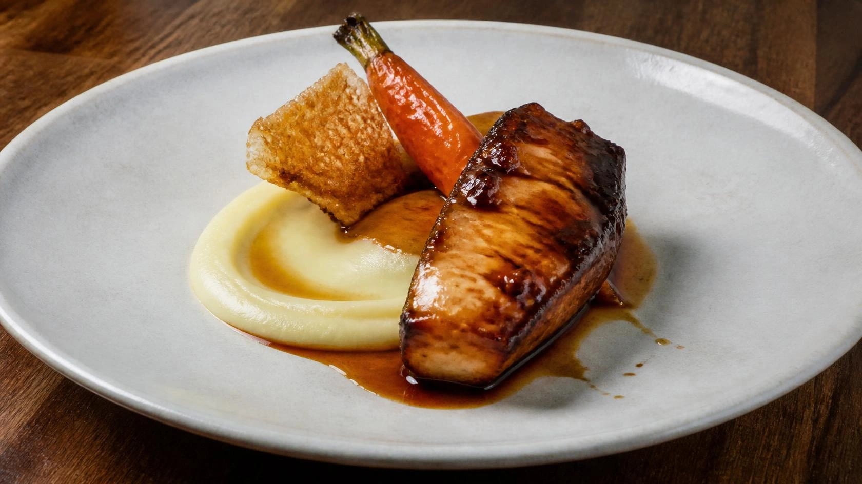AI-made picture of Tare Glazed Monkfish, Onion Purée, Confit Carrot, Chicken Skin
